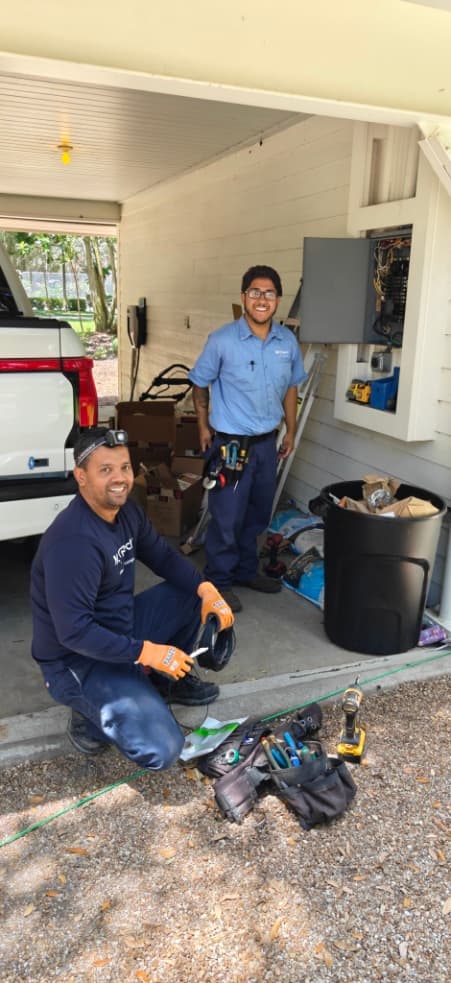 Mr. Electric technicians preparing for a garage panel service visit