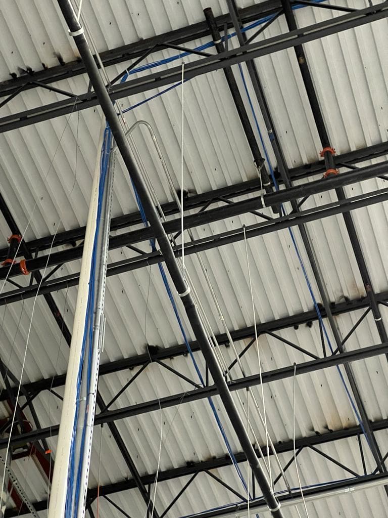 Electrical conduit and device boxes installed along a rack