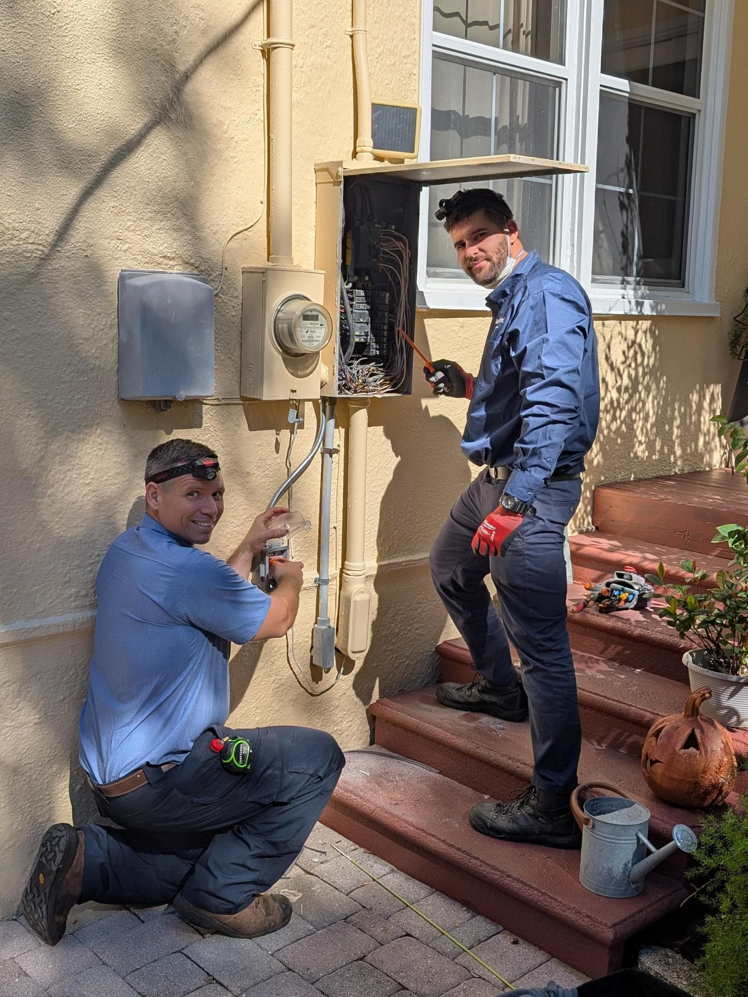 Mr. Electric technicians completing exterior service work