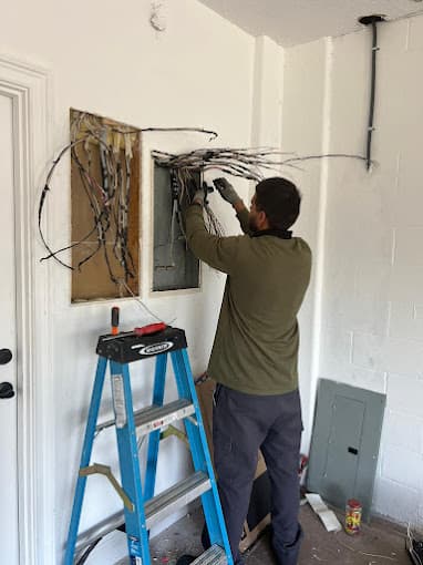 Technician working on interior wiring during rough-in electrical work