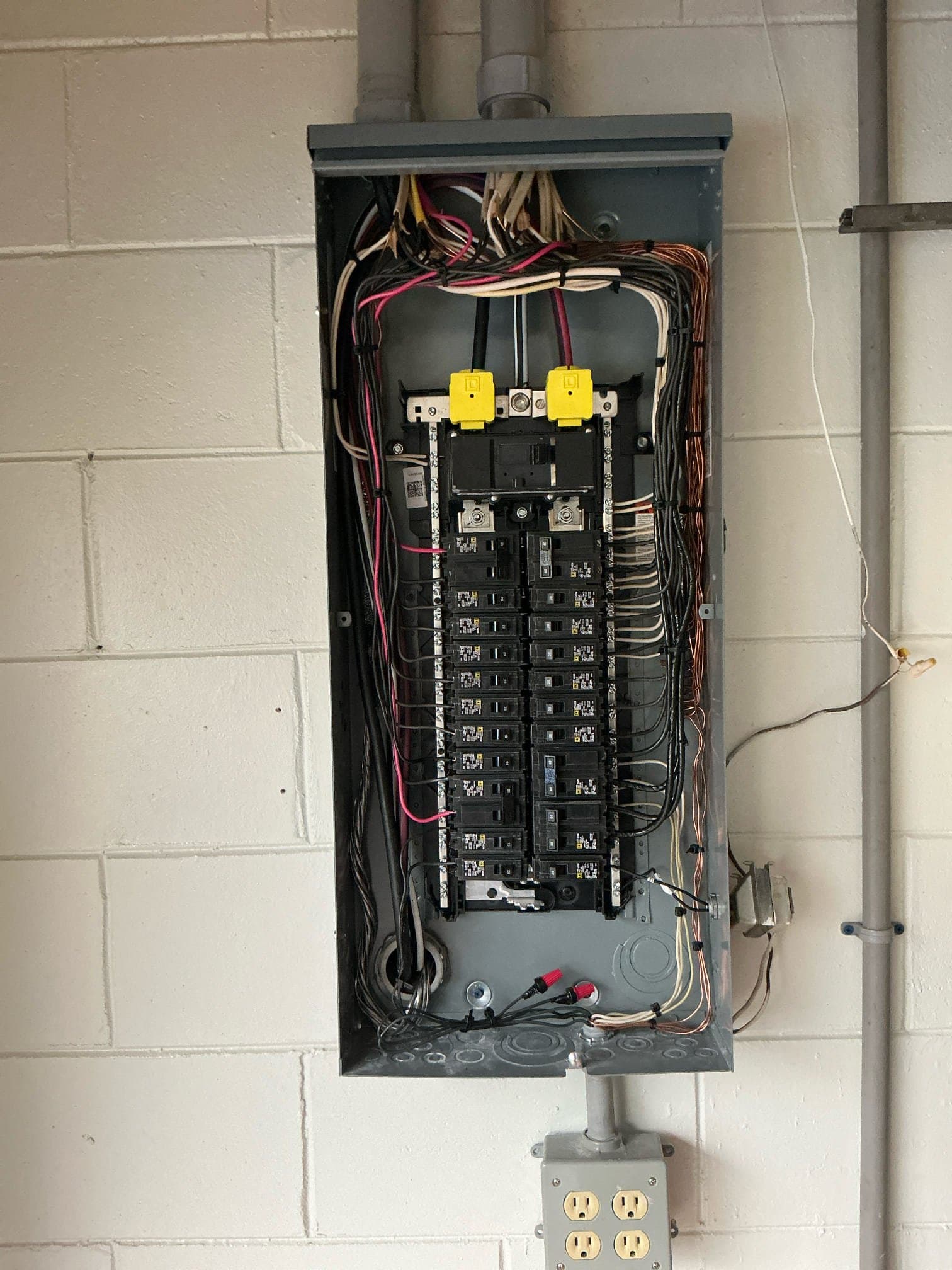 Electrical panel with breakers being inspected